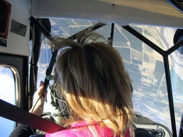Jenny flying, banking over farmland