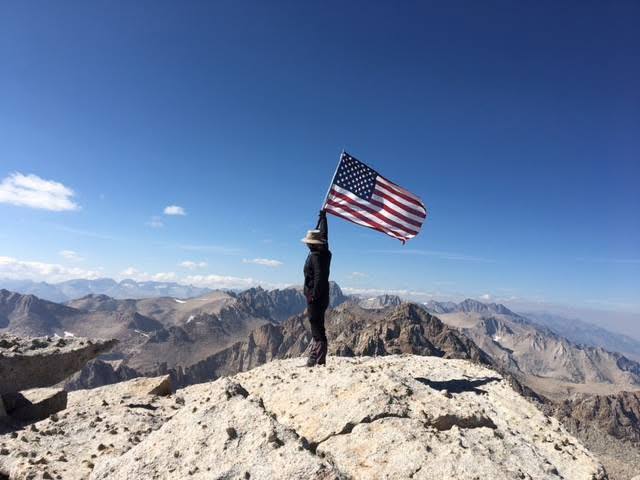 Jenny on the summit with American flag